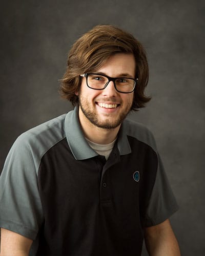 a man with glasses and a black shirt