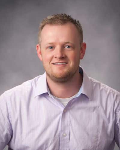 a man in a white shirt is posing for a photo