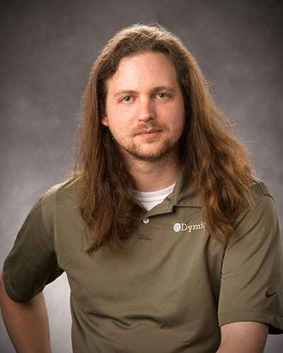 a man with long hair wearing a polo shirt