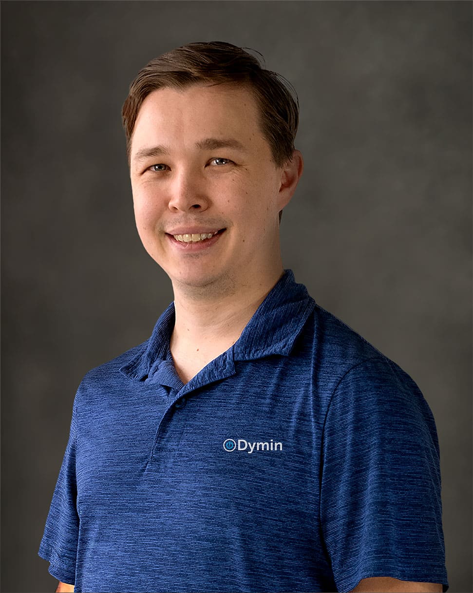 a man in a blue shirt smiling at the camera