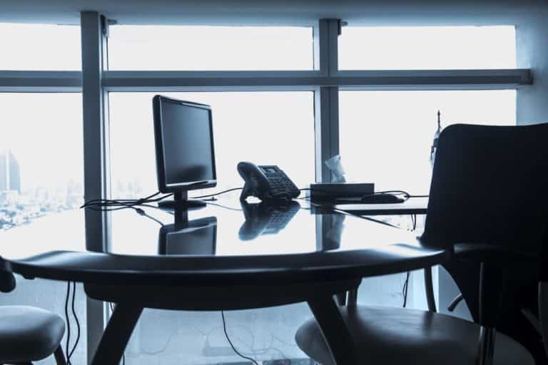 a desk with a computer monitor and keyboard on it