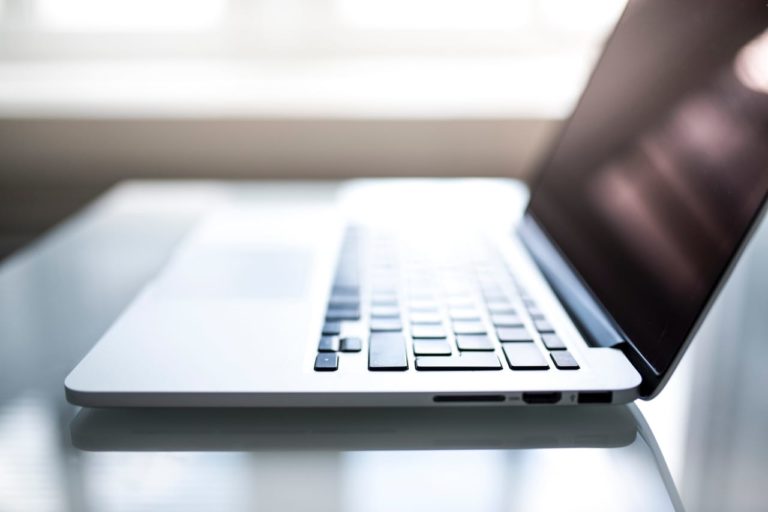 a laptop computer sitting on top of a table