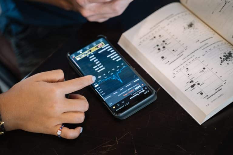 a person using a cell phone on a table