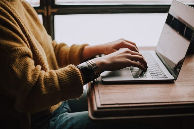 person sitting front of laptop