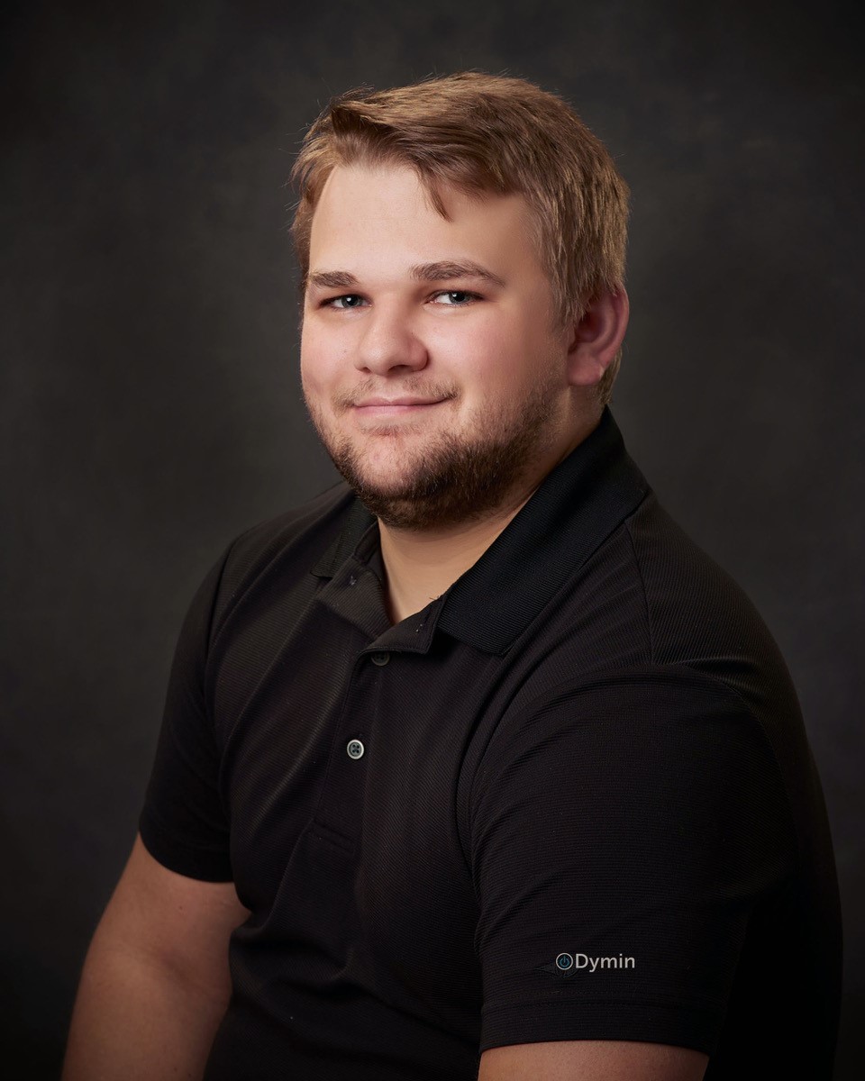 a man in a black shirt posing for a photo