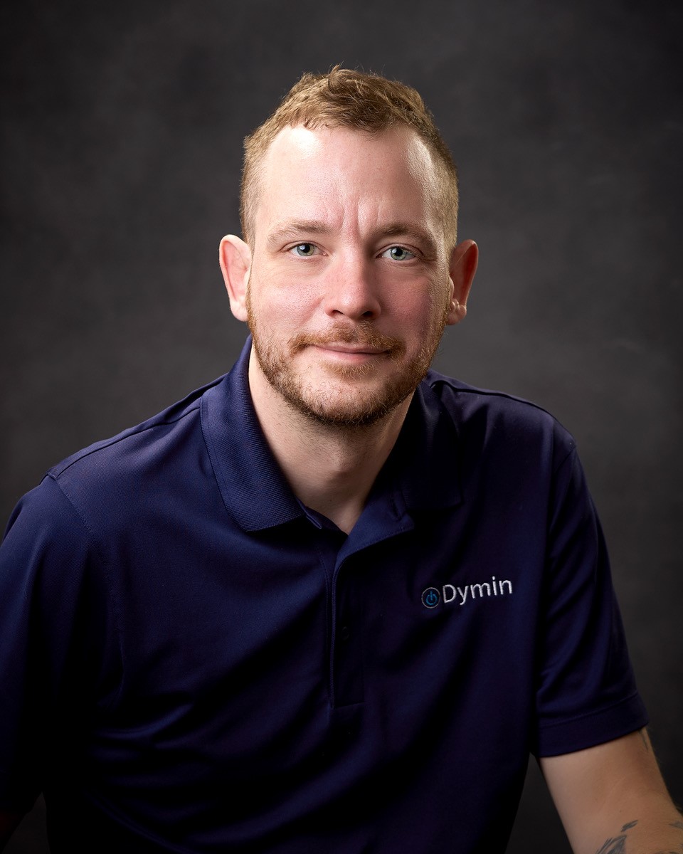 a man in a blue polo shirt posing for a photo