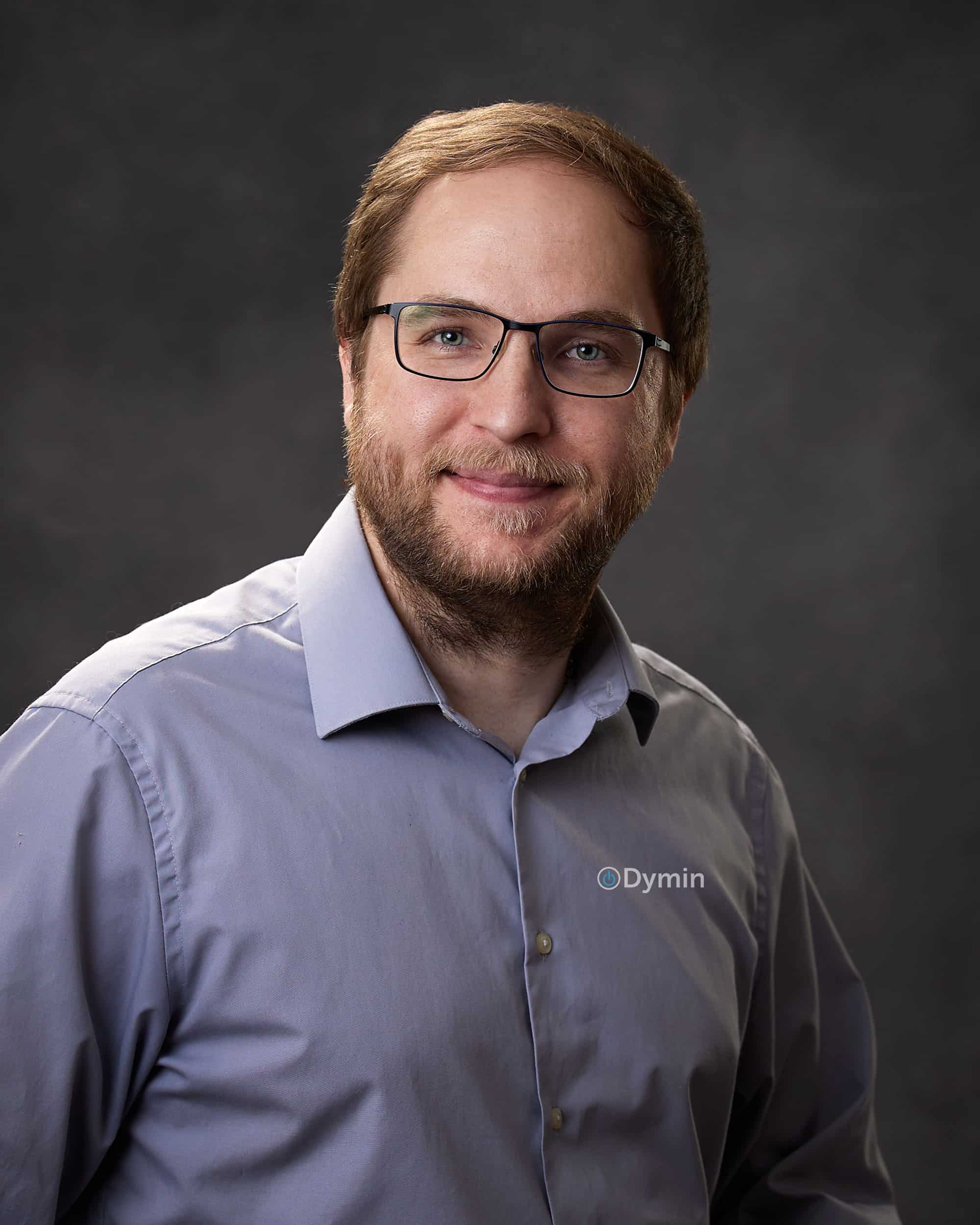 a man wearing glasses and a blue shirt