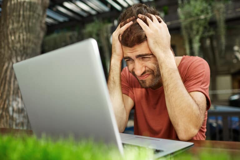 a man sitting in front of a laptop computer