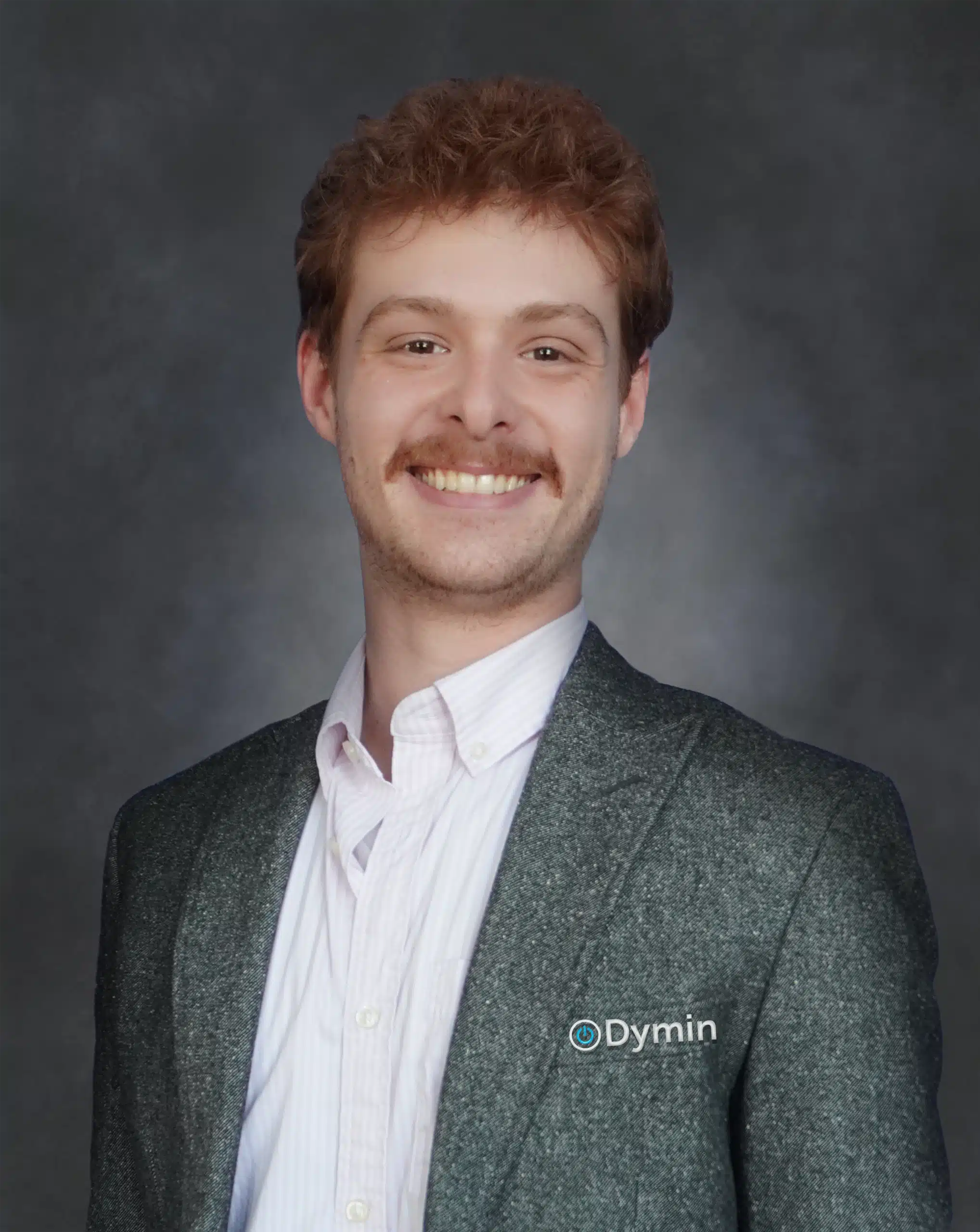 a man in a suit smiling at the camera