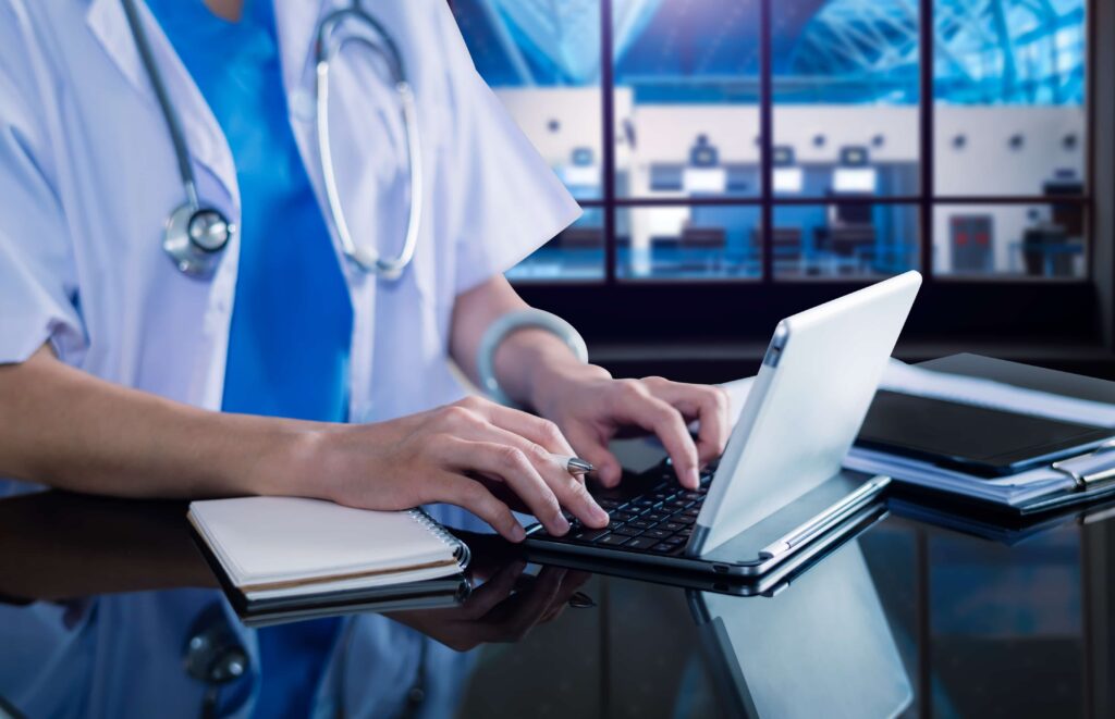 a person using a laptop computer on a desk