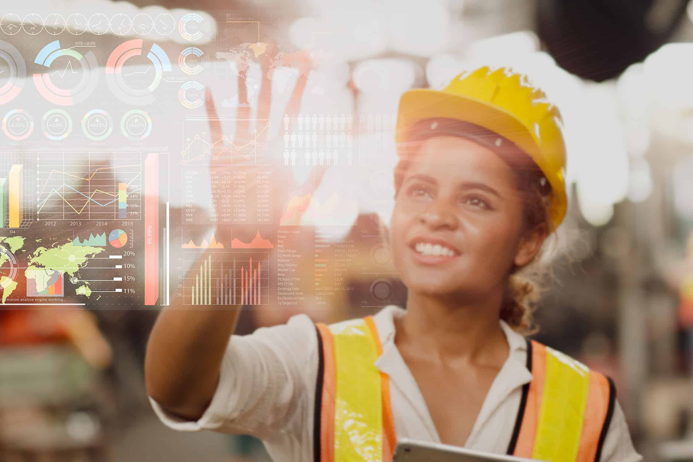 a woman in a yellow safety vest holding up a tablet