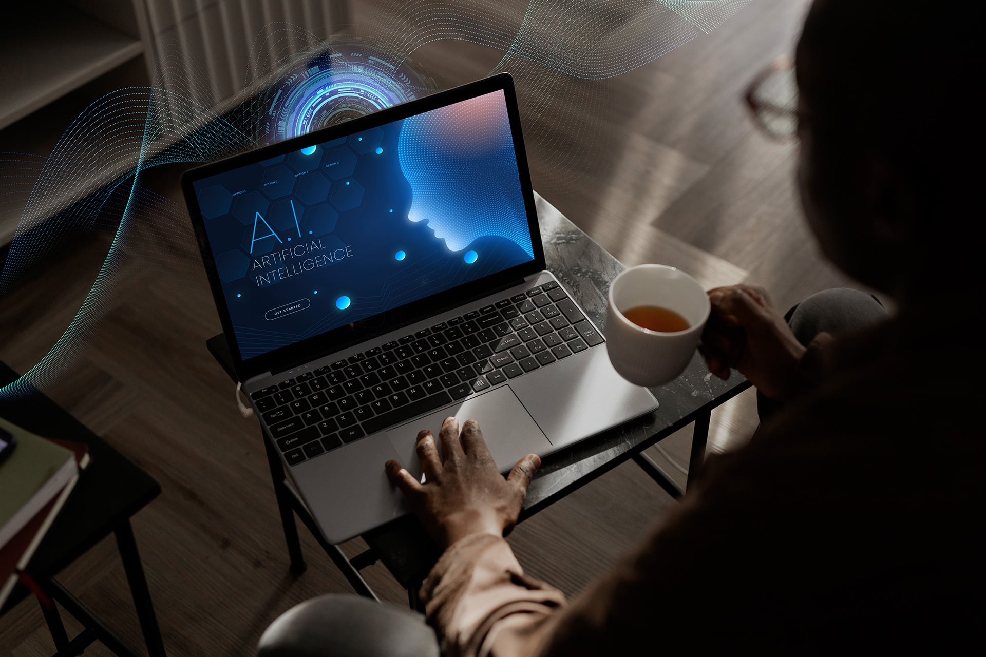 a person sitting at a table with a laptop