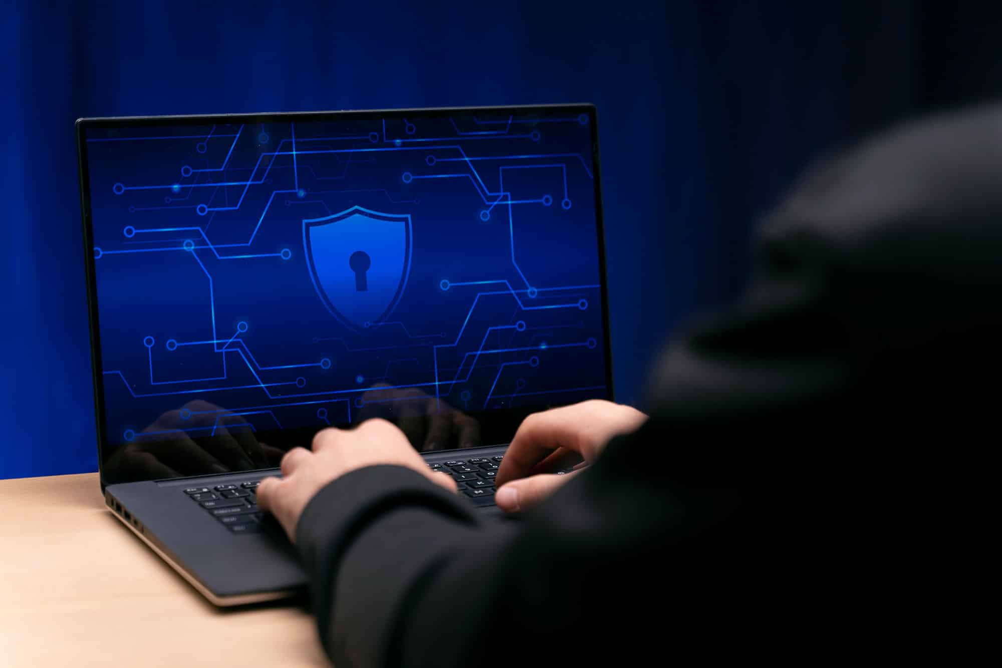 a person sitting in front of a laptop computer