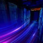 a long exposure photo of a hallway with blue and purple lights