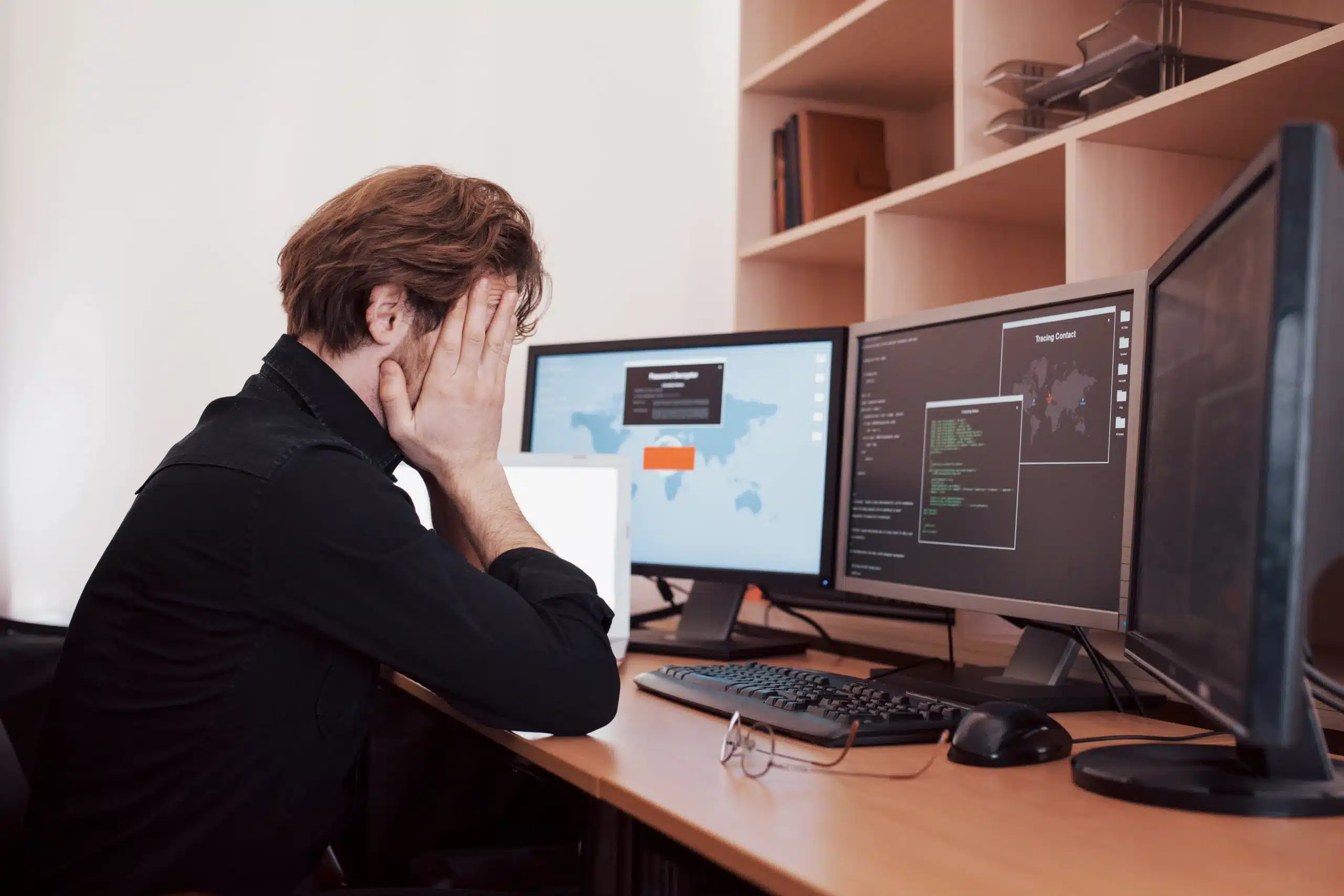 a person sitting at a desk with a computer