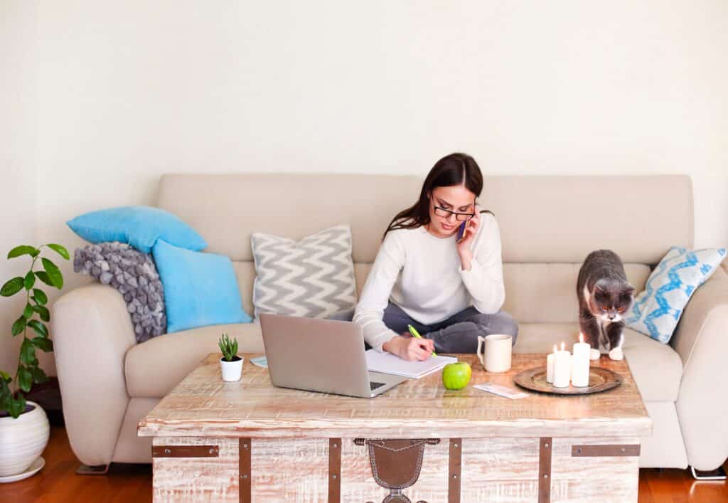 a woman sitting on a couch using a laptop