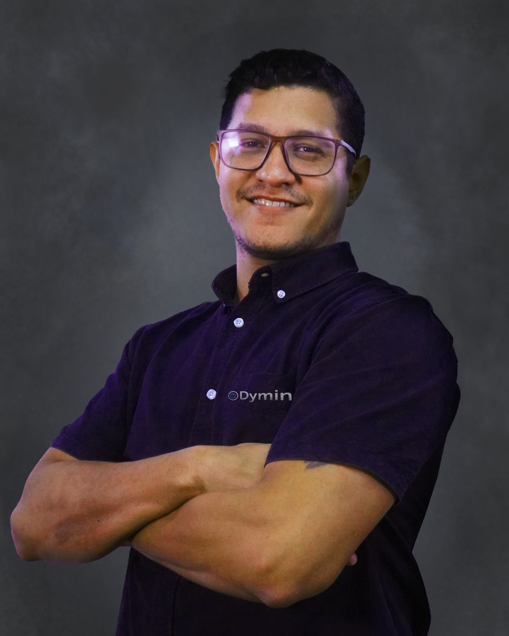 a man with glasses standing with his arms crossed