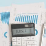 a calculator sitting on top of a pile of papers