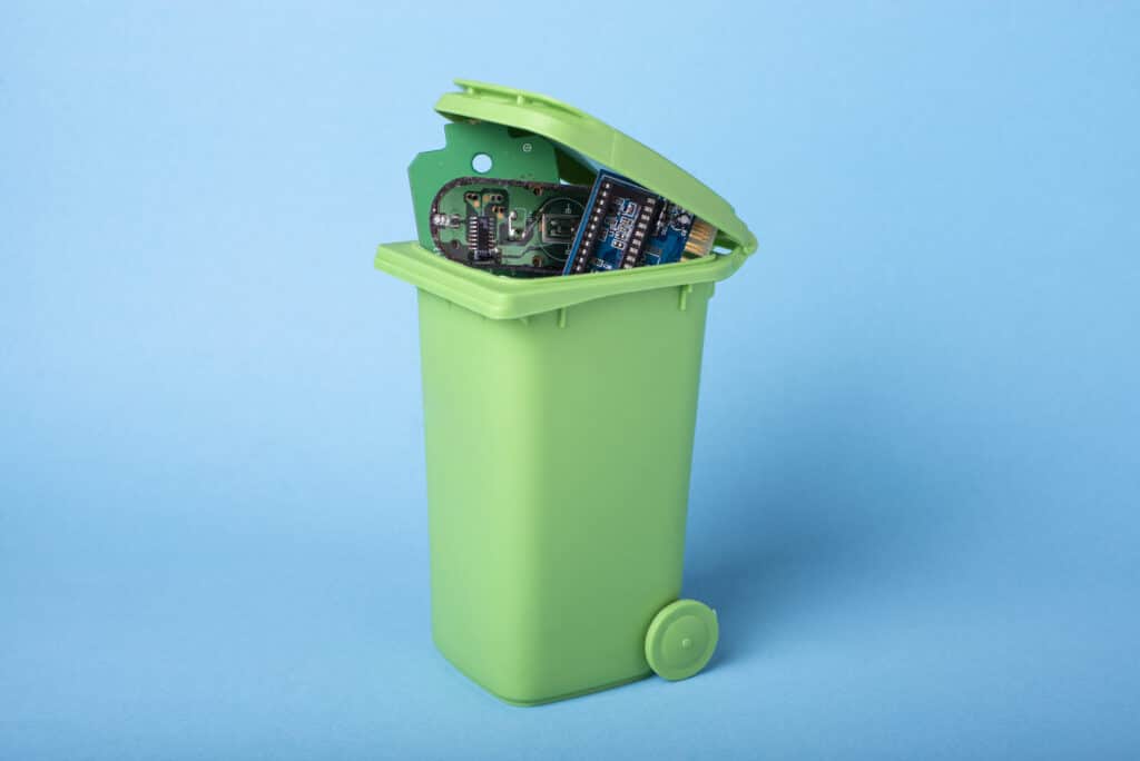 a green trash can filled with books on a blue background