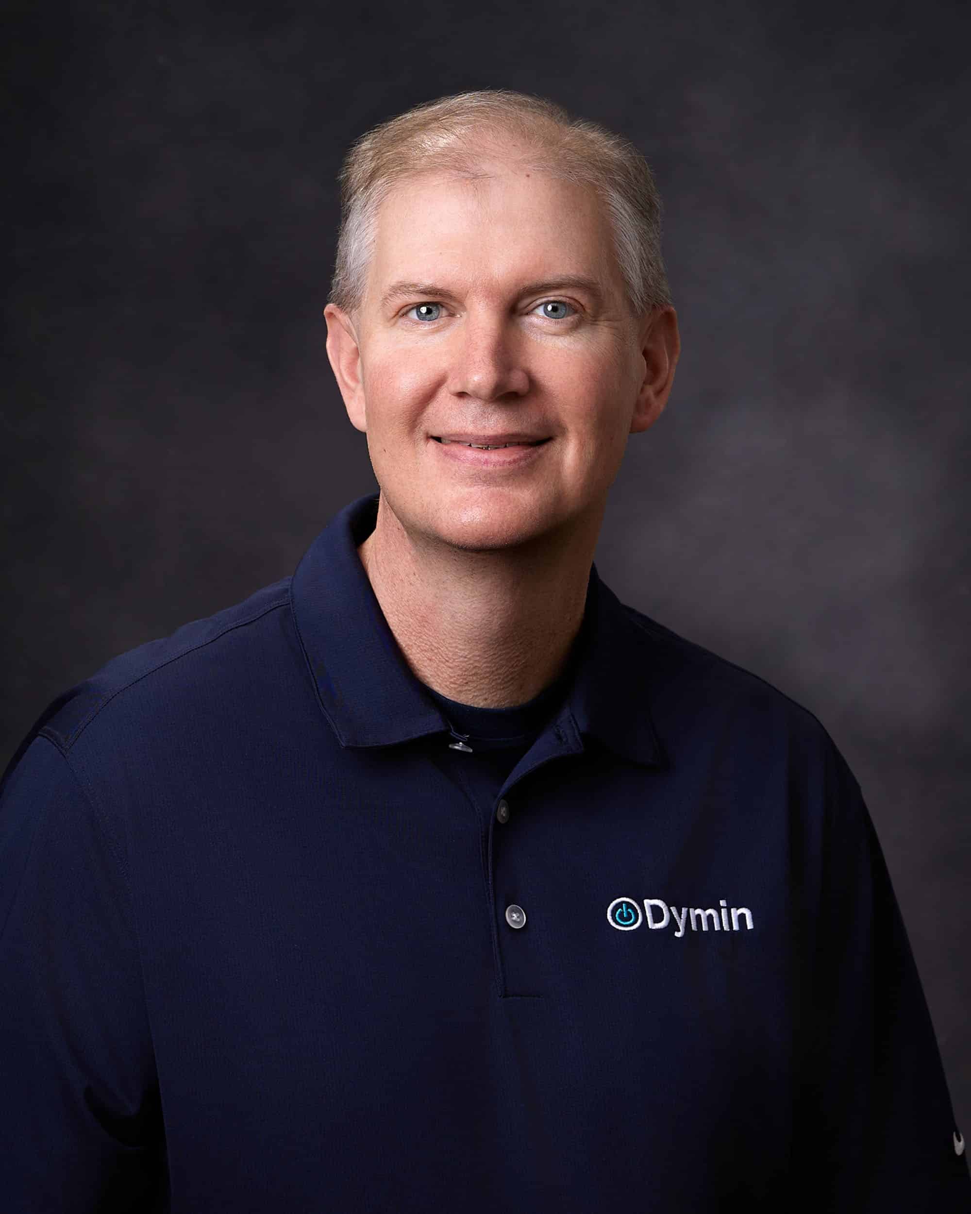 a man in a blue shirt is posing for a picture